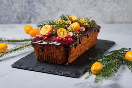 New Year's gingerbread cake with kumquat, dried berries and fruits. A festive dessert decorated with...