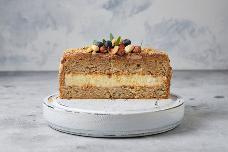 Homemade cake with cream, nuts and berries on a gray backgroundの写真素材