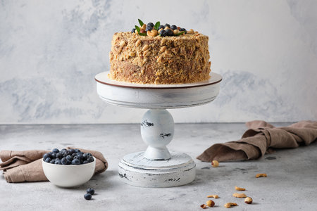Homemade cake with blueberries and hazelnuts on light backgroundの写真素材