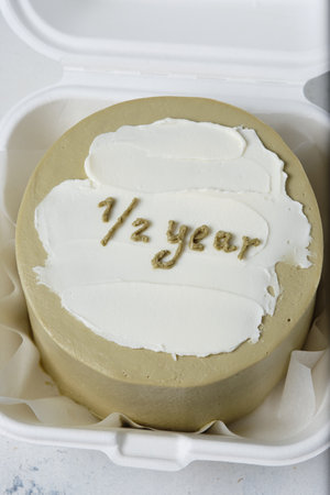 Bento cake for the holiday. A small cake with a picture or a congratulation for one person. Funny surprise dessert for kids.の写真素材