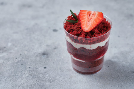 Trifle red velvet with cream cheese cream and raspberry filling. Dessert is decorated with fresh strawberries.の写真素材