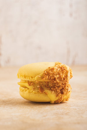 Macaron with tropical filling. One macaron is filled with chocolate, cream, mango and passion fruit ganache.の写真素材