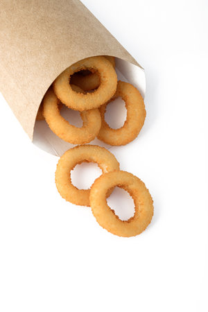 Fried onion rings in packaging on a white background. Serving for a bar, menu.の写真素材