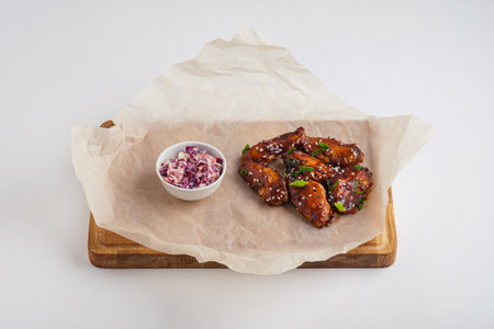 Chicken wings in teriyaki sauce with coleslawの写真素材