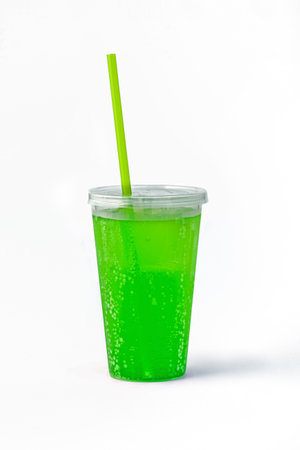 Non-alcoholic lemon, lime, mint, kiwi cocktail in disposable plastic container on white background.