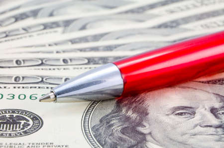 the red pen macro on dollar backgroundの写真素材