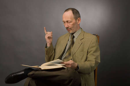 the portrait of senior man with book