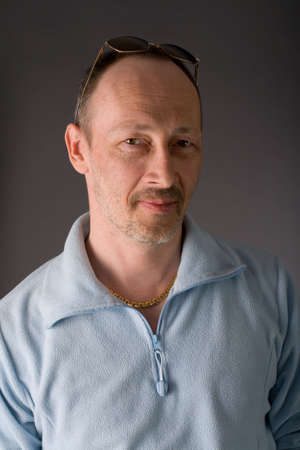 the portrait of senior man on grey background
