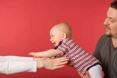 the mother, father and son on red backgroundの写真素材