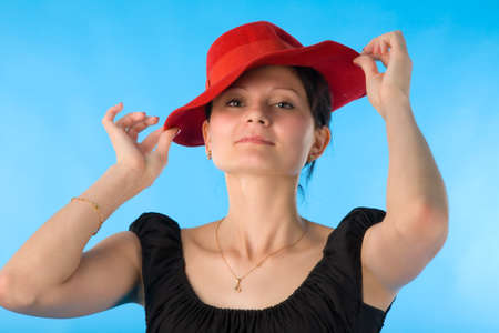 the portrait of woman in red hat on blue backgroundの写真素材