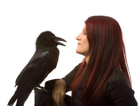 young woman with black raven on white backgroundの写真素材