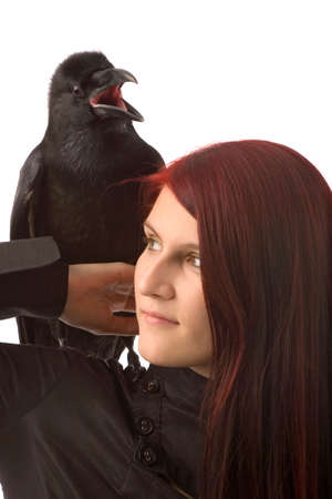 young woman with black raven on white backgroundの写真素材