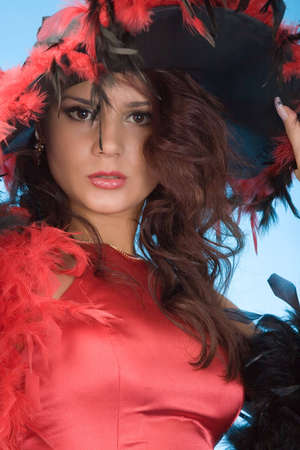 young pretty woman in hat with plumageの写真素材