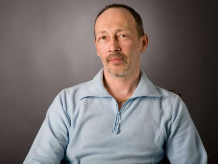 portrait of senior man on grey backgroundの写真素材