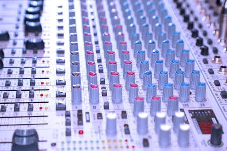 the control panel of sound mixer, close-up, blue tone