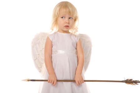 small girl with arrow dressed as angel on white backgroundの写真素材