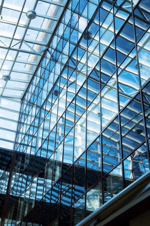 the futuristic business center roof construction from glass and steelの写真素材