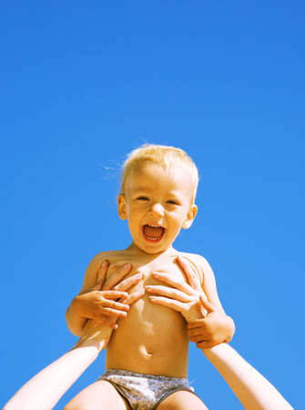 closeup portrait of the gladness boy on a sky backgroundの写真素材