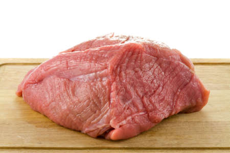 a closeup photo of a raw steak on a kitchen board on a white backgroundの写真素材