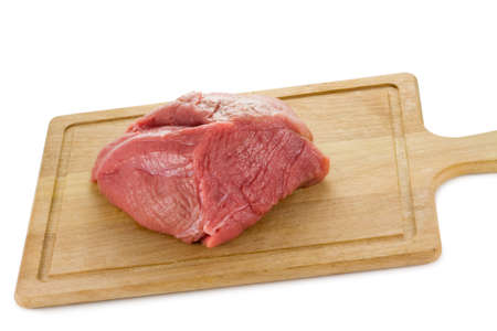 a closeup photo of a raw steak on a kitchen board on a white backgroundの写真素材