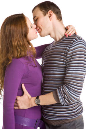closeup portrait of the young loving couple kissing  on white backgroundの写真素材