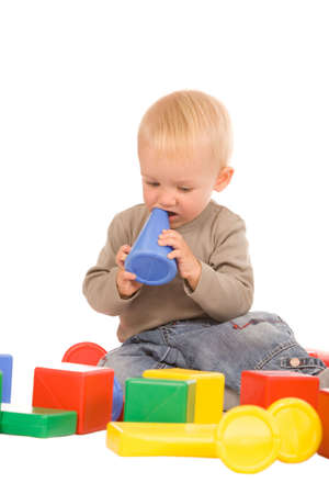 closeup portrait of the young boy playing with a educational toy isolated on a white backgroundの写真素材