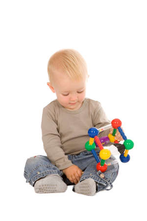 portrait of the young boy playing with a educational toy isolated on a white backgroundの写真素材
