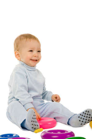 closeup portrait of the young boy playing with the educational toys isolated on a white backgroundの写真素材