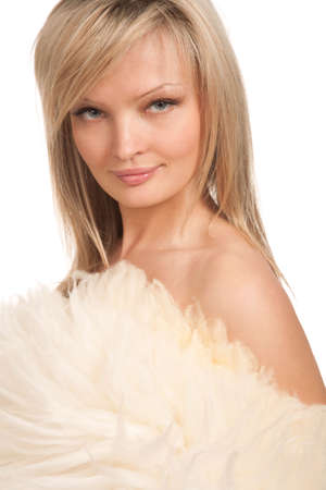 portrait of a blond woman behind sheep skin on white backgroundの写真素材