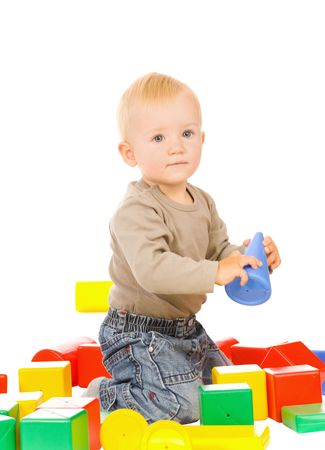 little boy play with bricks. isolated on a white backgroundの写真素材