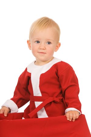little boy dressed as Santa Claus on a white backgroundの写真素材