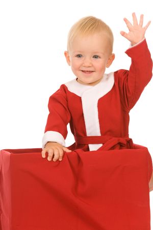 little boy dressed as Santa Claus on a white backgroundの写真素材