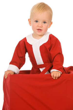 little boy dressed as Santa Claus on a white backgroundの写真素材