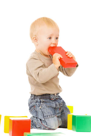 little boy play with bricks. isolated on a white backgroundの写真素材