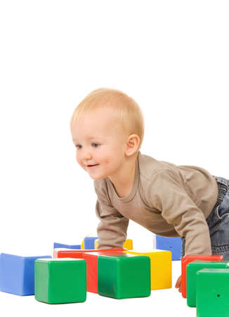 little boy play with bricks. isolated on a white backgroundの写真素材
