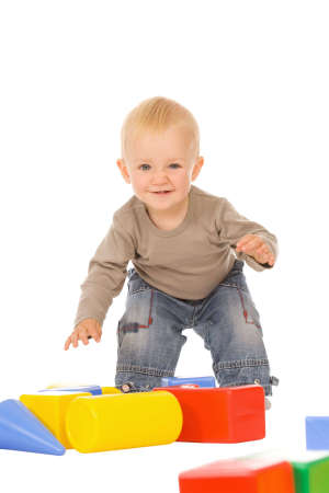 little boy play with bricks. isolated on a white backgroundの写真素材