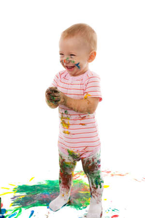 portrait of the little boy covered with bright paintの写真素材
