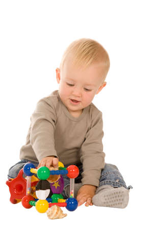 little boy play with toys. isolated on a white backgroundの写真素材