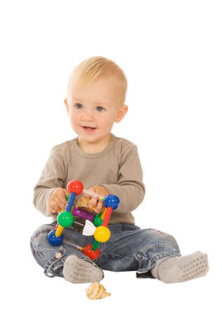 little boy play with toys. isolated on a white backgroundの写真素材