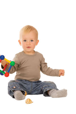 little boy play with toys. isolated on a white backgroundの写真素材