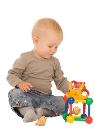 little boy play with toys. isolated on a white backgroundの写真素材