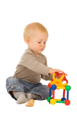 little boy play with toys. isolated on a white backgroundの写真素材