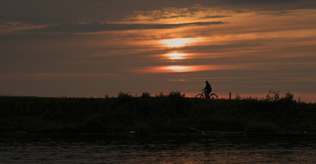 Hill with a Bicycle at sunset の写真素材