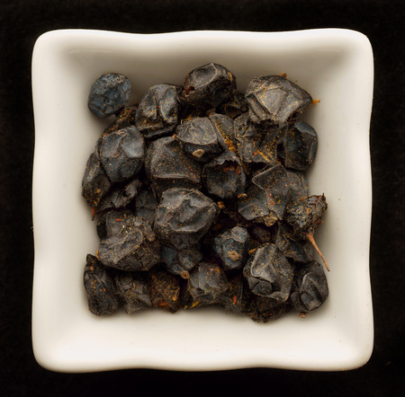 barberry in a ceramic bowl. Isolated on black.の写真素材