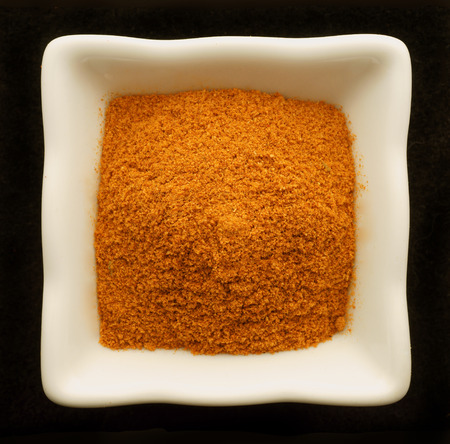Spice curry in a ceramic bowl. Isolated on black.の写真素材