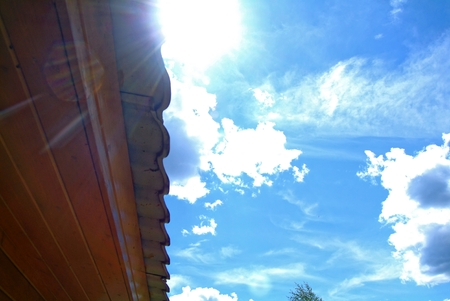 the sun shines through the cumulonimbus clouds in summer, against the blue sky