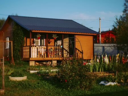 small village house in summer evening, Russia