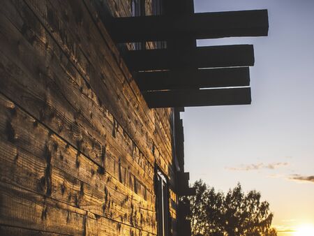 sunlight on the wall of a wooden house, Russiaの写真素材