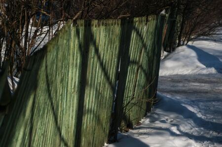 rural house behind a fence in winter, Moscowの写真素材
