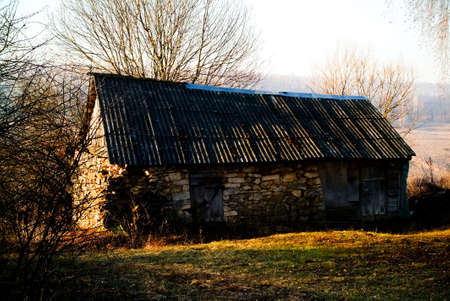 old stone barn in the village in spring, Russiaの写真素材